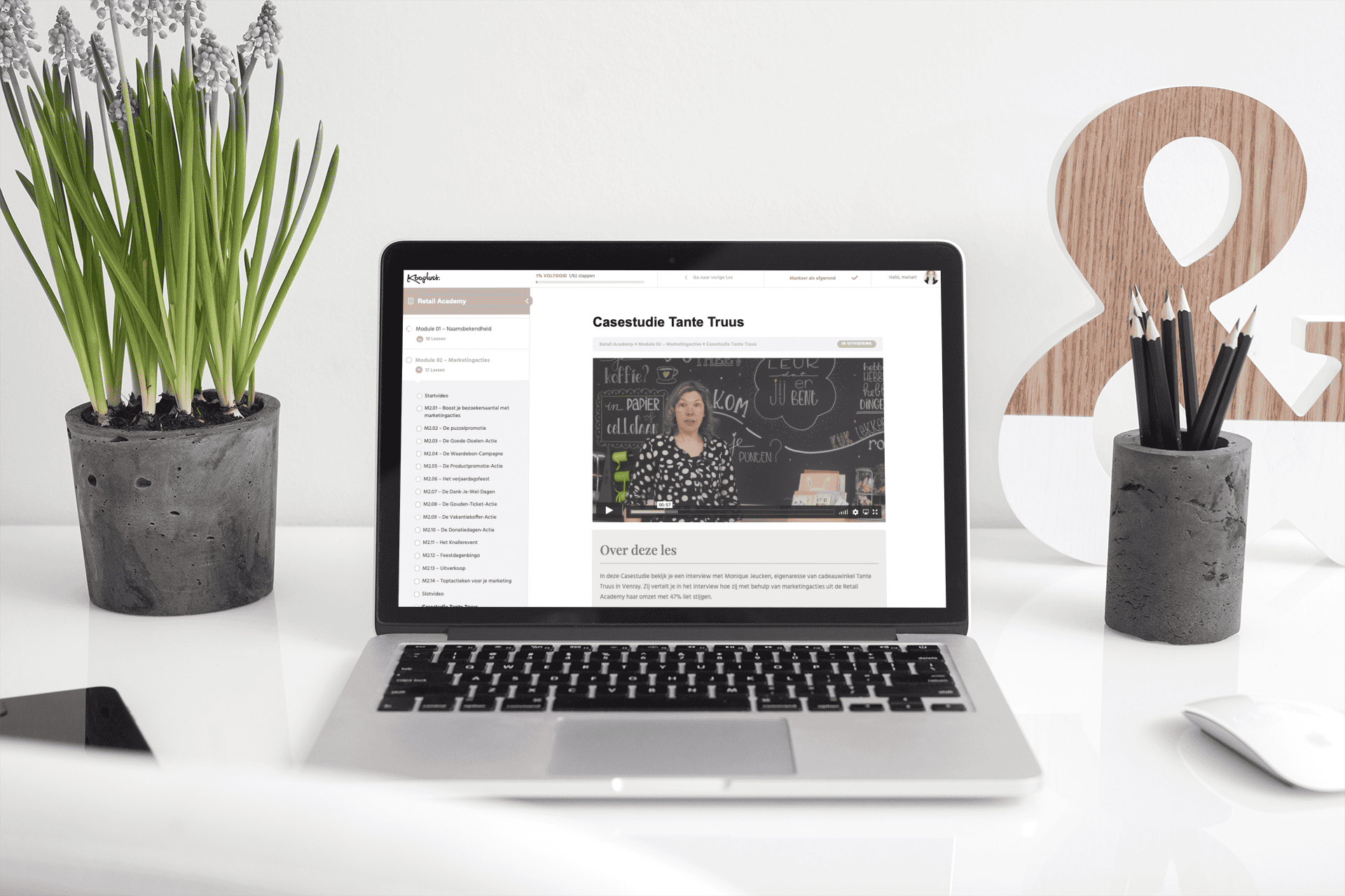 mockup-of-a-macbook-pro-placed-on-a-white-work-desk-and-next-to-a-plant-pot-484-el